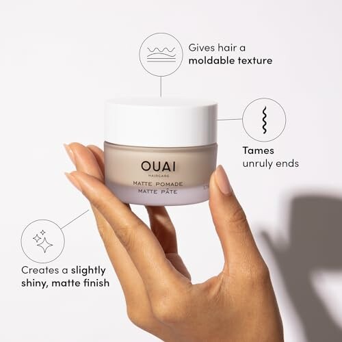 Hand holding Ouai Matte Pomade with text highlighting features like moldable texture and matte finish.