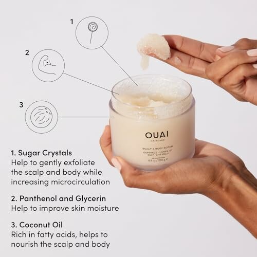 Hands holding OUAI scalp and body scrub with sugar crystals, panthenol and glycerin, and coconut oil.