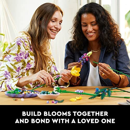 Two people crafting flowers together at a table.