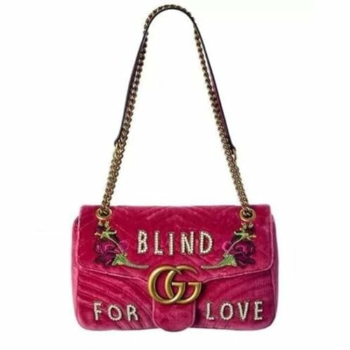 Pink velvet Gucci bag with floral embroidery and 'Blind for Love' text.