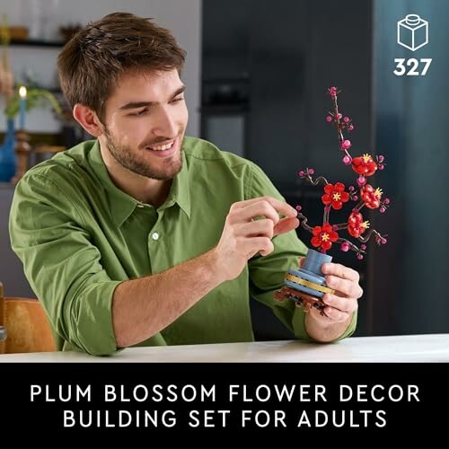 Man assembling a plum blossom flower decor building set.