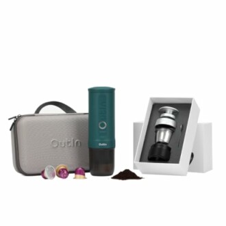 Portable coffee maker kit with capsules, carrying case, and accessories.