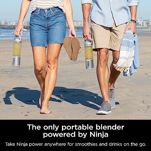 Couple walking on beach with portable Ninja blenders.