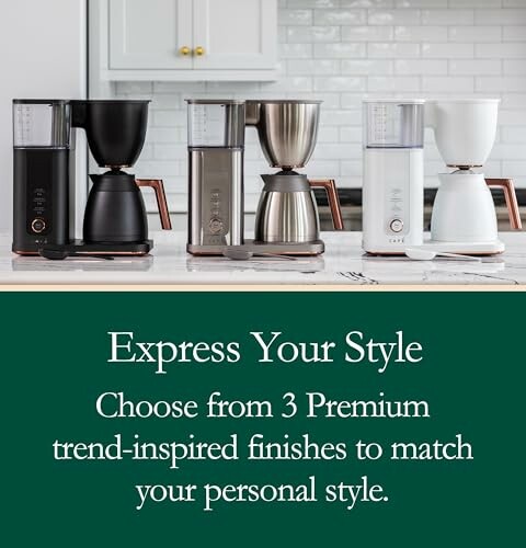 Three premium coffee makers in black, silver, and white finishes on a kitchen counter.