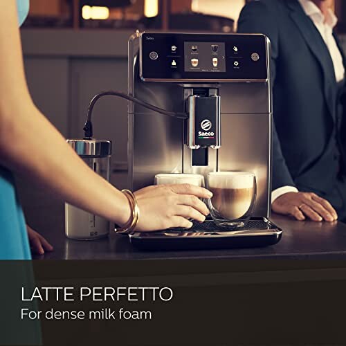 Saeco coffee machine making latte with dense milk foam