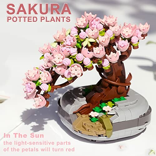 Lego model of a sakura tree in bloom with pink flowers.