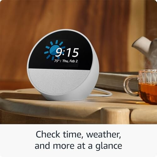 Smart clock showing time and weather with a cup of tea.