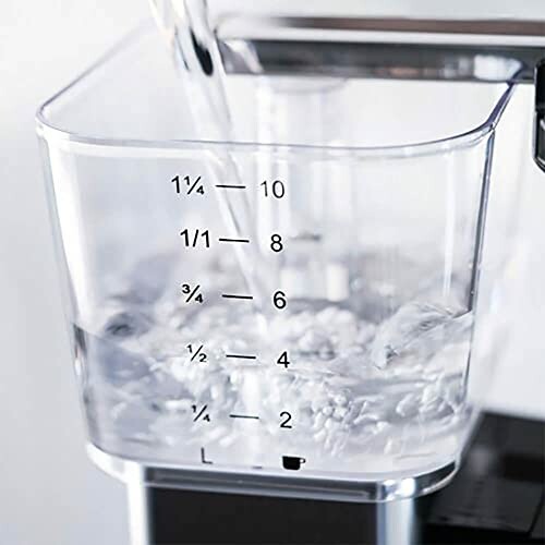 Water being poured into a clear measuring container.