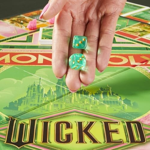 Hand holding dice over Wicked-themed Monopoly board.