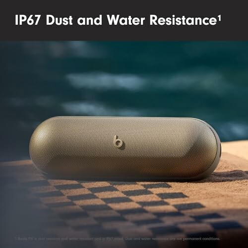 Wireless speaker with IP67 dust and water resistance on a towel.