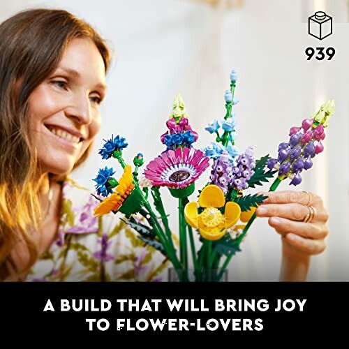 Woman assembling colorful LEGO flower set.