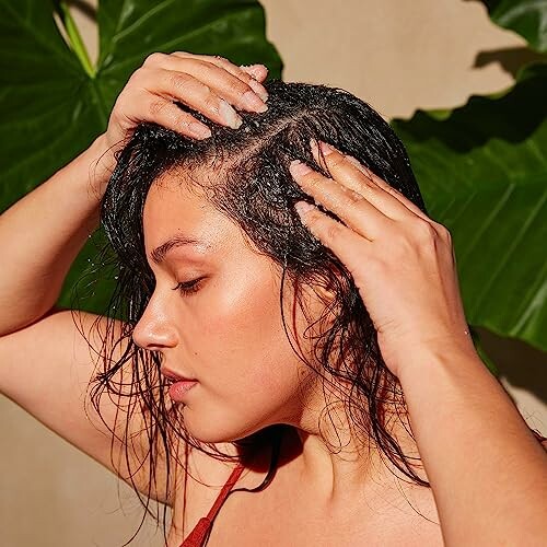 Woman massaging shampoo into her wet hair